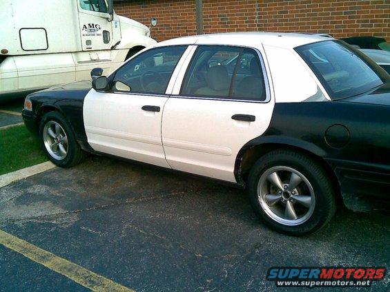 2003 Ford Crown Victoria police car, two-tone black and white paint, aftermarket wheels