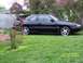 1989 Mazda MX-6 - A black coupe sits on a grassy lawn with flowering bushes in the background. The date 04/22/2008 is watermarked on the image.