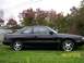 1989 Mazda MX-6 - Side profile of a black 1989 Mazda MX-6 GT coupe with distinctive star wheels.