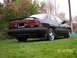 1989 Mazda MX-6 - A 1989 Mazda MX-6 is shown from the rear quarter angle, parked on a grassy lawn.