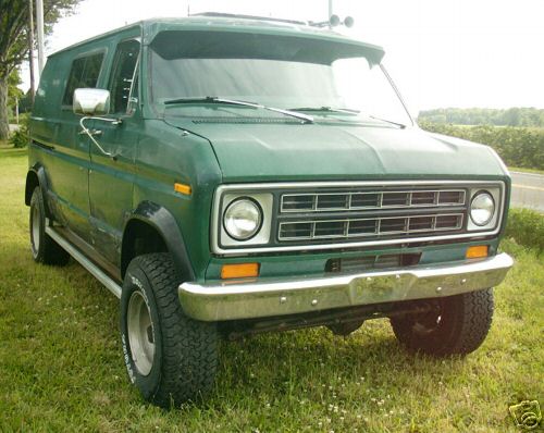 Green van with chrome bumper and grille, parked on grass