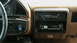 1990 Ford Bronco - The dashboard features a dual-DIN radio setup and wood-grain trim accents.