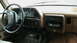 1990 Ford Bronco - The interior of a 1987 Ford F-150 truck, a tan dashboard, steering wheel, and aftermarket radio.