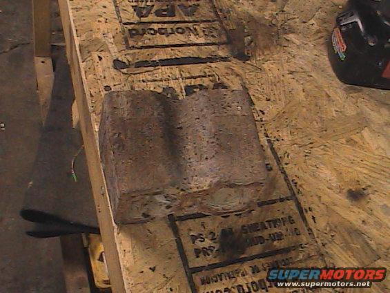 Rusted metal part on plywood with text