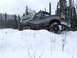 1988 Ford Bronco - Ford Bronco navigates a snowy terrain with tall trees visible behind it.