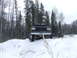 1988 Ford Bronco - A lifted Ford Bronco navigates a snow-covered terrain surrounded by a dense forest.