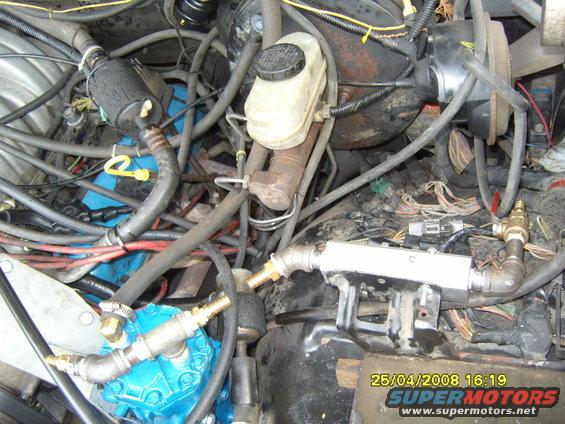 Engine bay with blue compressor and plumbing. Date stamp 25/04/2008