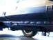 1995 Mercury Grand Marquis - Rocker panel rust repair on a vehicle, showing damage and undercoating.