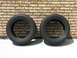 2003 Ford Crown Victoria - A pair of tires are displayed in front of a brick wall, with a Supermotors.net logo in the lower right corner.