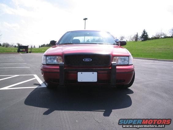 Red 2001 Ford Crown Victoria front view with a black push bar and a blank license plate