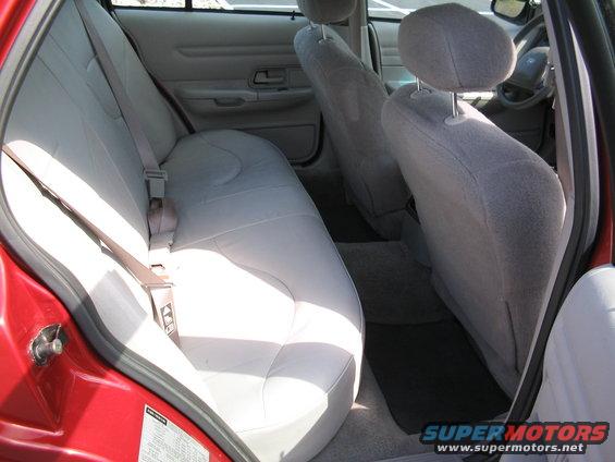 Red 2001 Ford Crown Victoria interior showing light gray cloth seats and door panel