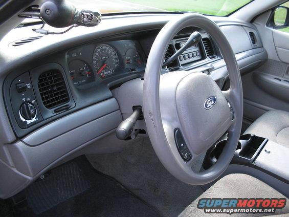 Interior dashboard of a 2001 Ford Crown Victoria, showing steering wheel, gauges, and center console