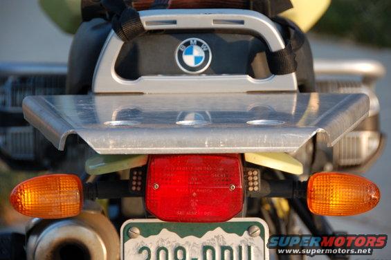Motorcycle rear rack with BMW logo and red taillight