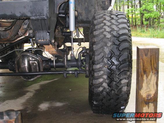 Close-up of a large off-road tire and suspension components on a vehicle