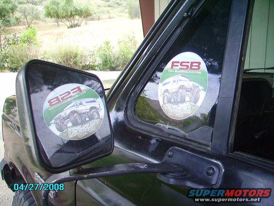 Black Ford Bronco side view with stickers on the window and side mirror