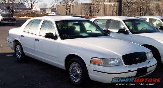 White sedan with a black grille and chrome hubcaps, viewed from the front-left