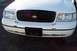 1999 Ford Crown Victoria - Front view of a white 1998 Ford Crown Victoria, its distinctive black grille and headlights.