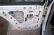 1996 Ford Crown Victoria - The interior of a white car door panel is visible, showing the internal mechanisms and wiring.