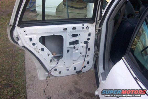 White 1996 Ford Crown Victoria door interior with wiring exposed, seen from the side