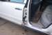1996 Ford Crown Victoria - Door panel removed on a 1996 Ford Crown Victoria, revealing interior components and gray leather seats.