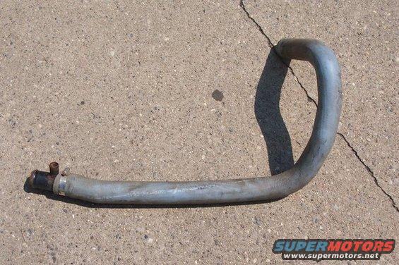 Metal oil cooler hose with black fitting and clamp, lying on concrete