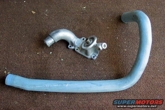Oil cooler and blue hose on brown carpet