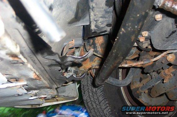 Undercarriage view showing suspension components and a tire