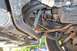 1996 Ford Crown Victoria - Close-up view of vehicle undercarriage components, showing hoses and suspension parts.
