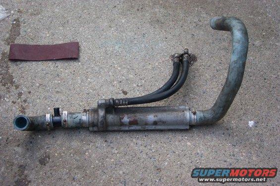 Oil cooler assembly with hoses and a piece of sandpaper on concrete