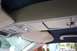 1996 Ford Crown Victoria - Interior view of a car's overhead console and sun visor, showing storage compartments and lighting.