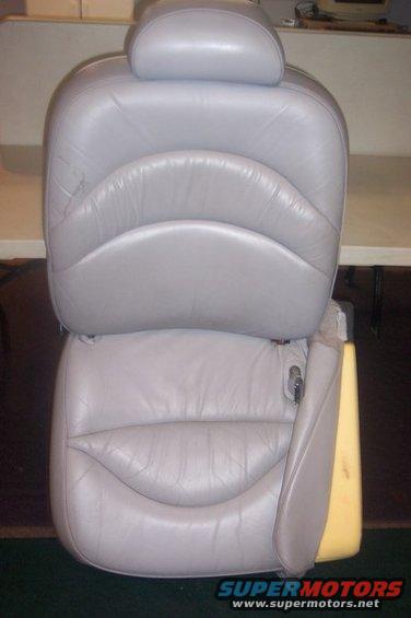 Light gray leather car seat with headrest and visible foam padding
