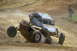 2008 Ford Bronco - Two off-road vehicles collide during a race, creating a dramatic scene on the dirt track.
