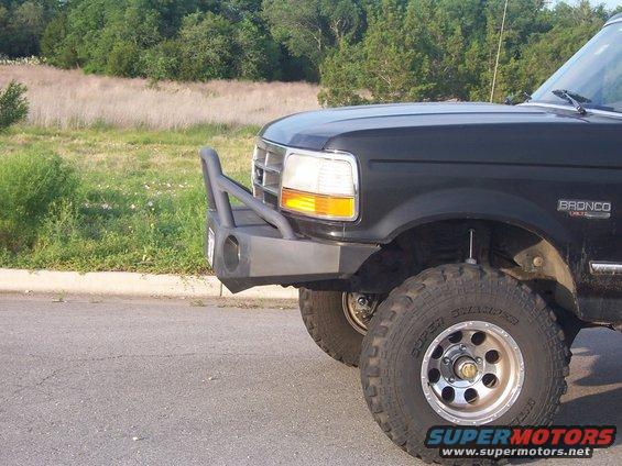 Black Ford Bronco front fender and aftermarket bumper, off-road tires, side view