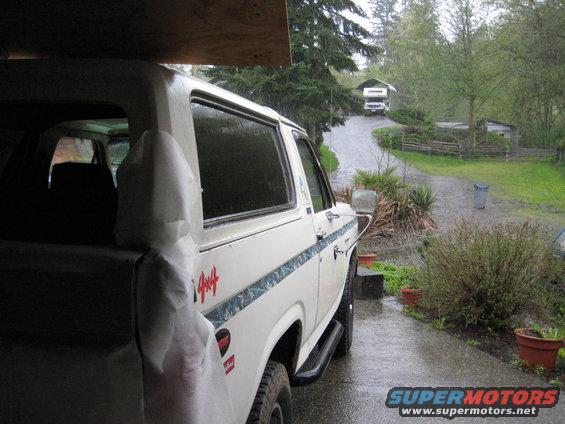 White SUV with 4x4 decal parked in driveway, RV visible in background