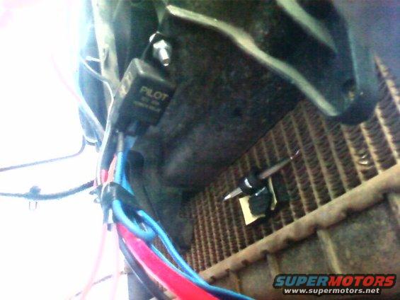 photo0213.jpg Temporary location for the relay, on the fan shroud.  Temp sender is located next to it.  I put it on the middle of the rad  iator because my truck has a nasty leak some days that'll drain up to 4" of coolant from the radiator, I wanted the sensor to be near coolant at all times.  You are looking at the passenger side of the radiator.