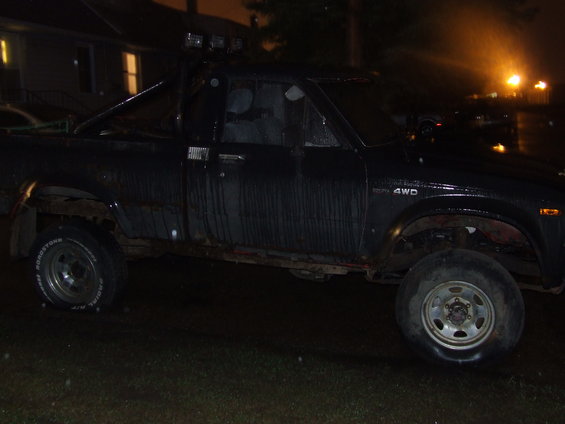 Black 1990 Ford Bronco, side view, parked at night