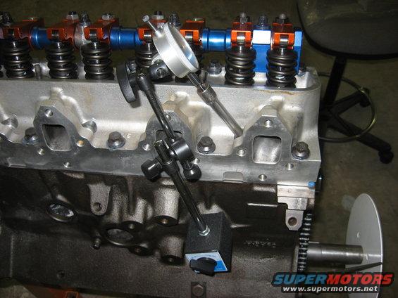 img_1269.jpg I devised a way to find TDC after torquing the head. 3/8" socket extension thru the plug hole. The magnetic mount is on top of the front freeze plug hole. 