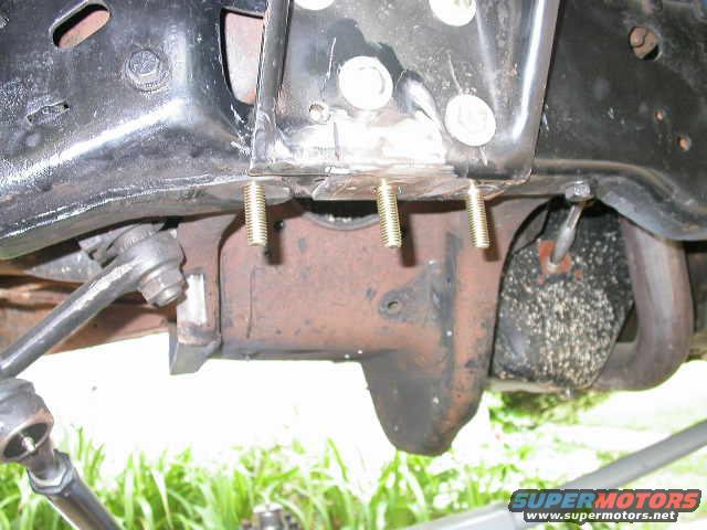 dscn6421.jpg I decided to make a bolt on upper trac bar mount instead of welding one on.  You can see here where I replaced three rivets with bolts.