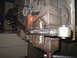 1979 Ford Bronco - A metal rod is secured in a vise, ready for modification with an angle grinder.