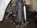 1979 Ford Bronco - The image shows the front suspension system of a vehicle, including the steering linkage, coil spring, and shock absorber.