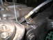 1979 Ford Bronco - Detail of a vehicle's brake system, showing a brake hose and suspension components.