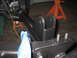 1979 Ford Bronco - A close-up view of a vehicle's suspension system, showing metal brackets and bolts.
