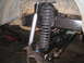 1979 Ford Bronco - Close-up view of a vehicle's front suspension and steering system components.