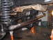 1979 Ford Bronco - Close-up view of the suspension and steering components of a vehicle, likely undergoing modifications or repairs.