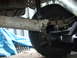 1984 Ford F-150 - Undercarriage view of a truck's rear axle and suspension components, with a blue tarp visible.
