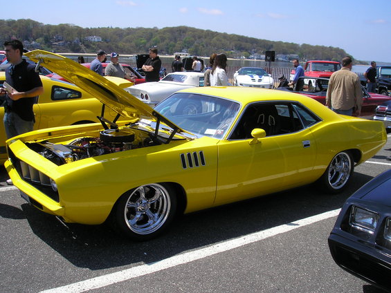 Yellow 1970 Plymouth Barracuda with hood open, showing engine