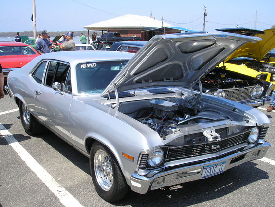 Silver 1960s Chevrolet Nova SS, hood open, showing engine. License plate TOXIC II