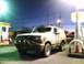 1995 Ford Bronco - A tan Ford Bronco is parked at a gas station at dusk.