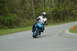 2007 Kawasaki Ninja R - Rider on a blue sportbike navigates a turn on a track, with trees lining the course.