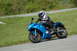 2007 Kawasaki Ninja R - A blue Kawasaki Ninja motorcycle is ridden on a paved road with a grassy embankment.